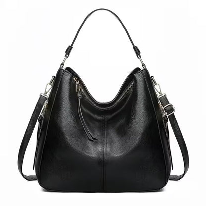 Black leather handbag with shoulder straps on a white background