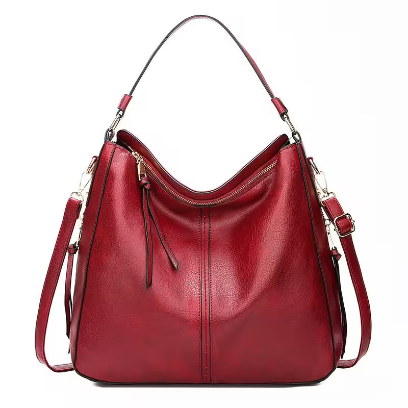 Red handbag with a strap on a white background