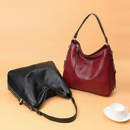 Black and red handbags on a beige background with a cup and saucer.