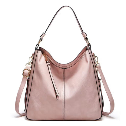 Pink handbag with gold accents on a white background