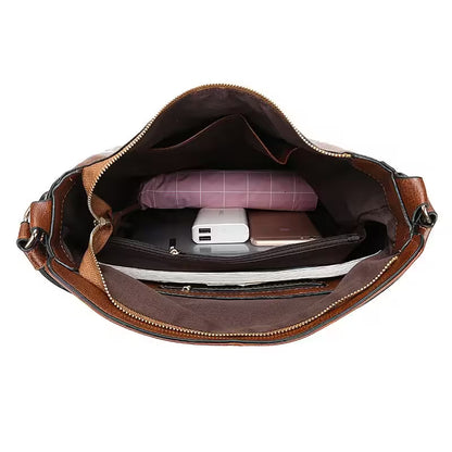 Brown leather bag with compartments containing a phone, tablet, and other items on a white background