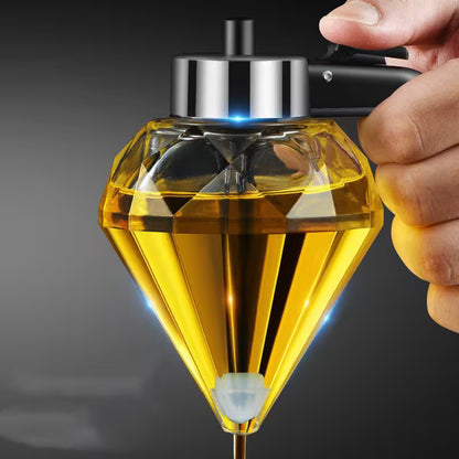 Diamond-shaped bottle with yellow liquid held by a hand against a dark background