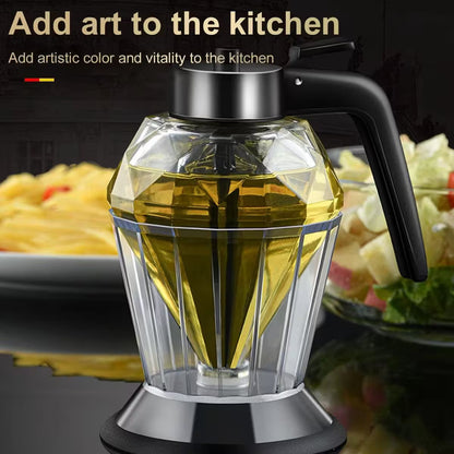 Glass oil dispenser with black handle on a kitchen counter with food in the background