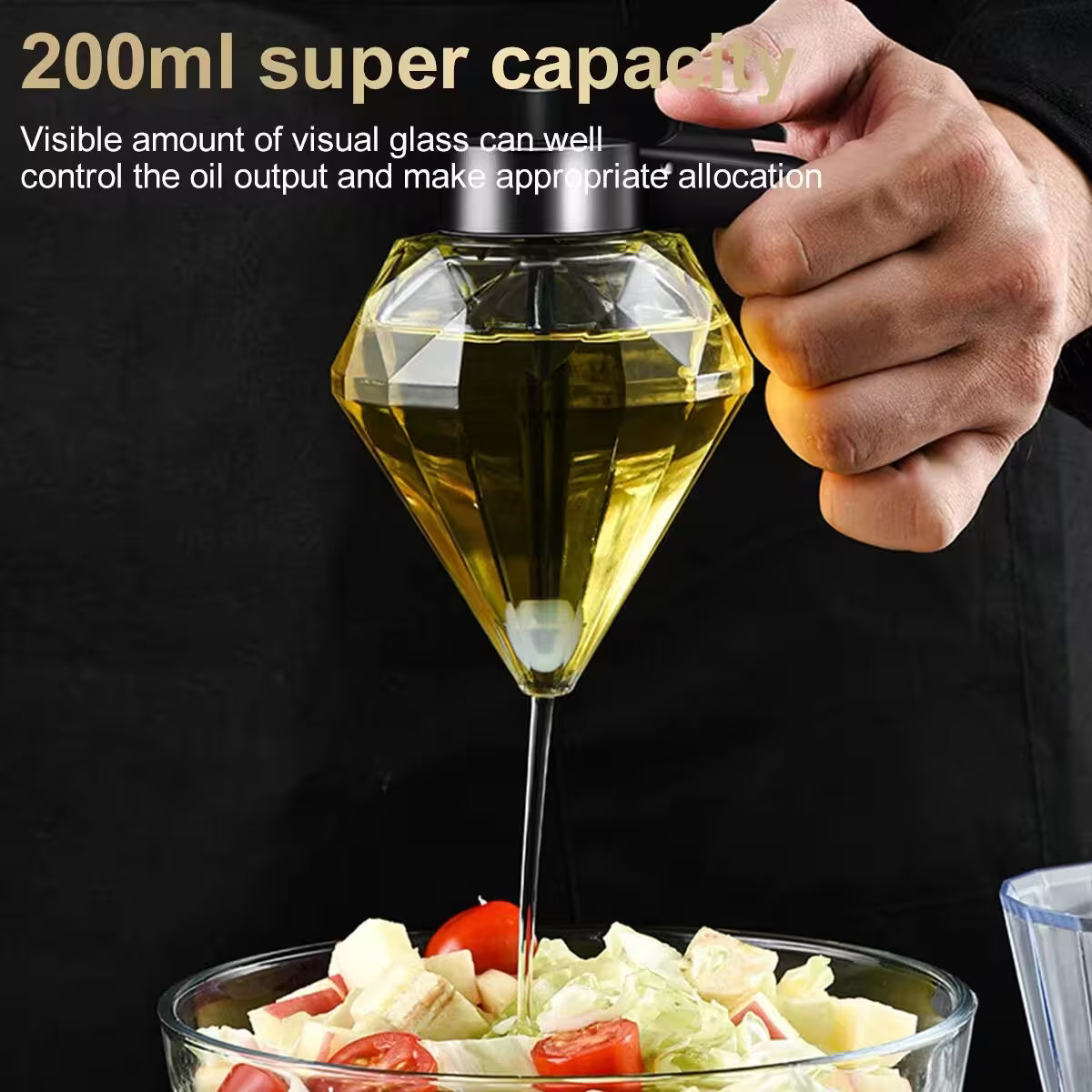 Diamond-shaped glass oil dispenser being used to drizzle oil over a salad with text about capacity and oil control.