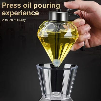 Diamond-shaped oil dispenser being used to pour oil into a glass container with text 'Press oil pouring experience' and 'A touch of luxury'.