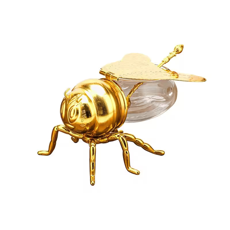 Gold bee-shaped object on a white background