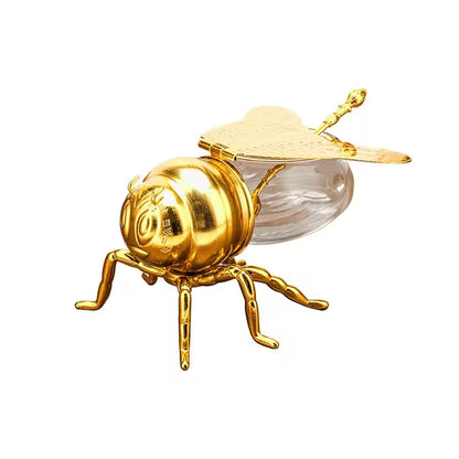Gold bee-shaped object on a white background