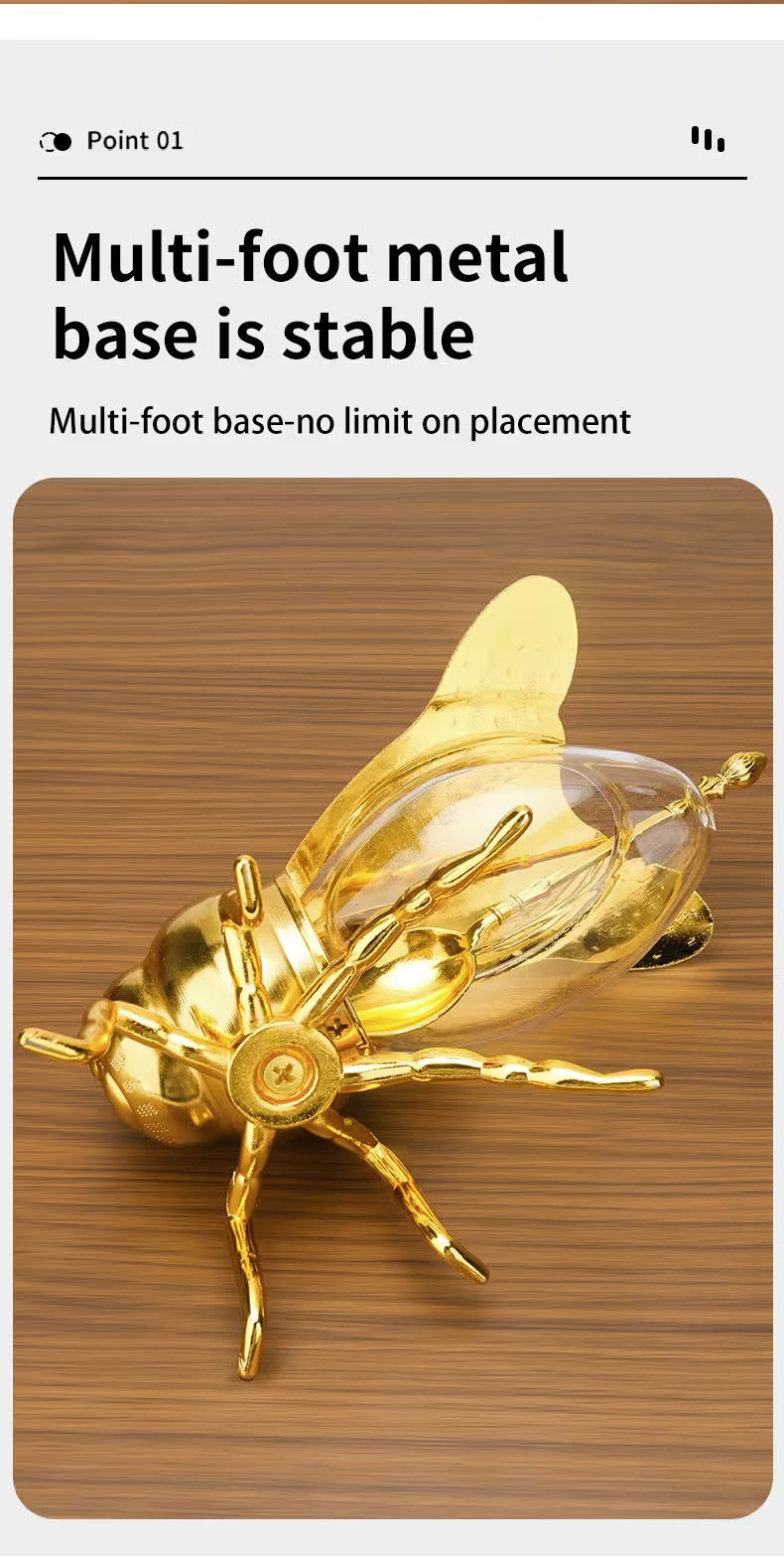 Gold insect-shaped lamp on a wooden base with text about stability.