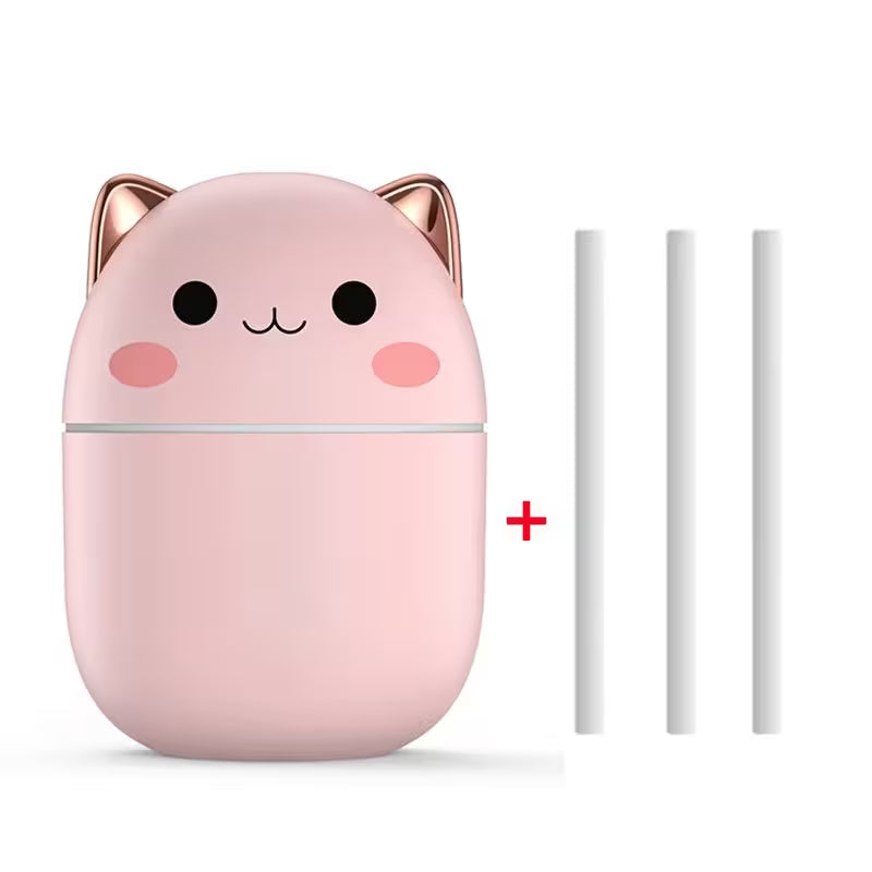 Pink cat-shaped humidifier with two white nozzles on a white background