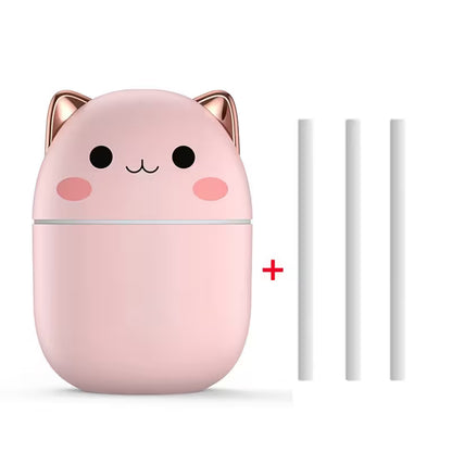 Pink cat-shaped humidifier with two white nozzles on a white background