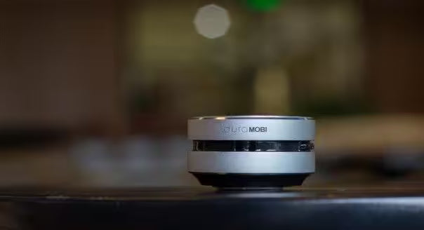 Small cylindrical device with 'Mobi' branding on a blurred background