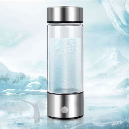 Glass water bottle with silver cap on a icy background
