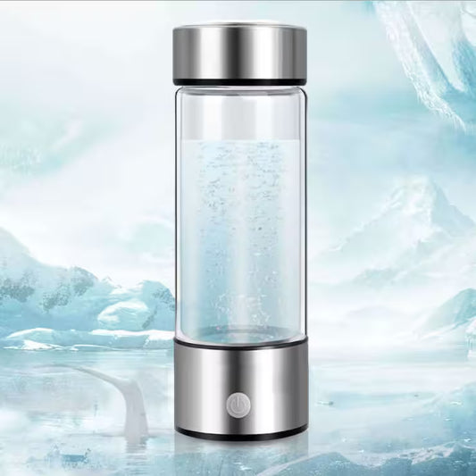 Glass water bottle with silver cap on a icy background
