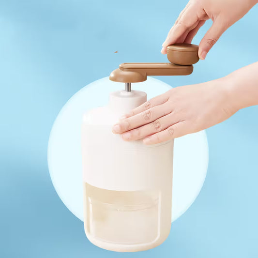 Hand using a beige and brown hand soap dispenser against a light blue background