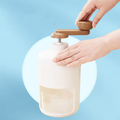 Hand using a beige and brown hand soap dispenser against a light blue background