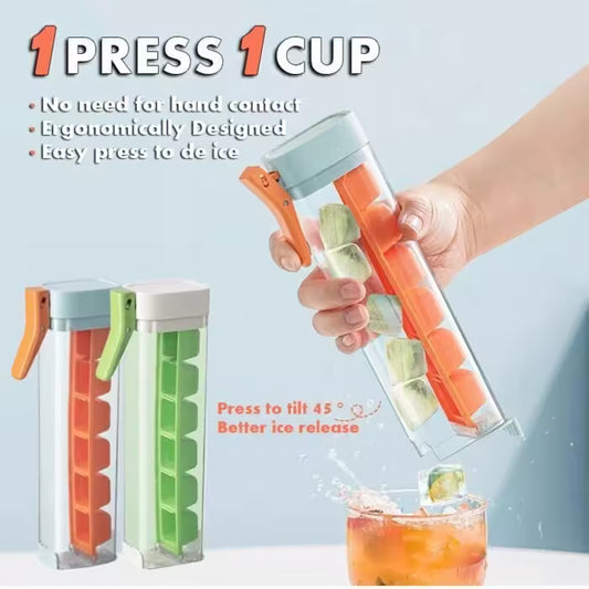 Ice cube tray with orange and green compartments, held by a hand over a glass of iced drink.