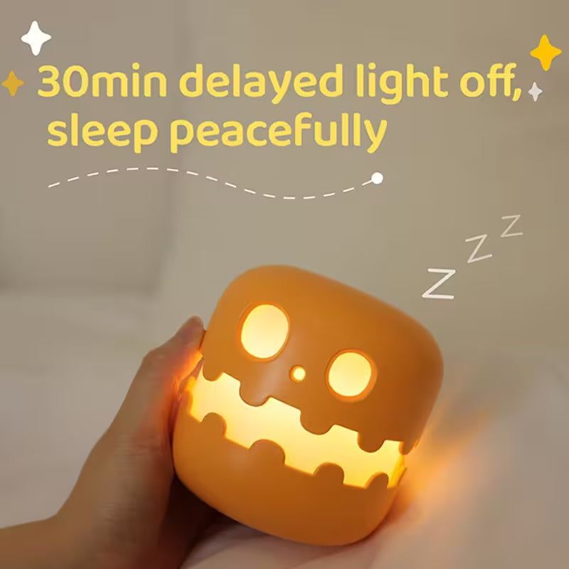 Cylindrical light with pumpkin face design held by a hand, on a neutral background with text about a 30-minute delayed light-off feature.