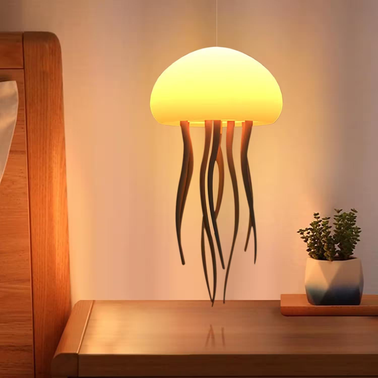 Jellyfish-shaped lamp on a wooden surface with a plant in the background