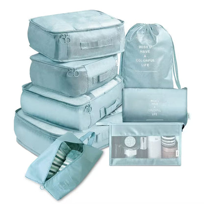 Set of light blue packing cubes and bags with text on a white background