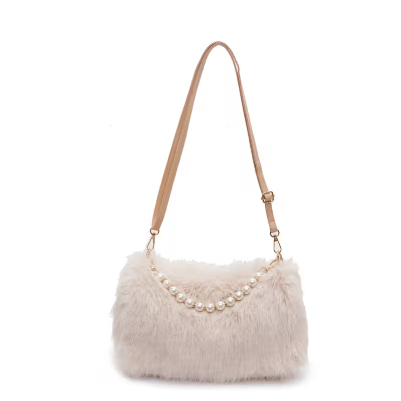 Beige fur handbag with pearl embellishments on a white background