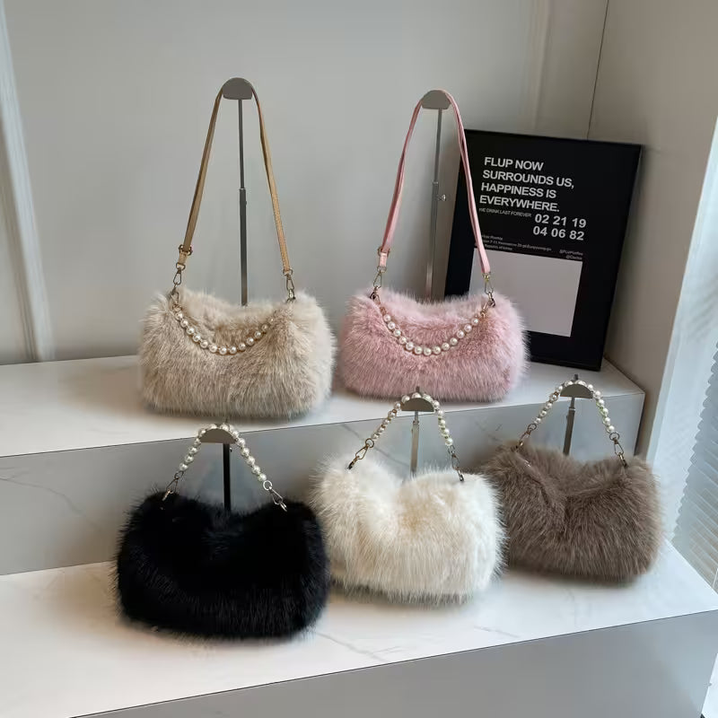 Set of five fluffy handbags in various colors on a white surface.