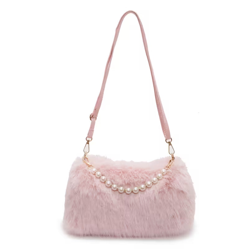Pink fur handbag with pearl chain on a white background