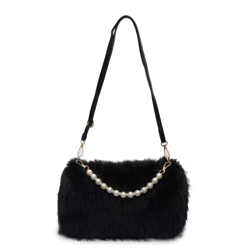 Black fur handbag with pearl handle on a white background