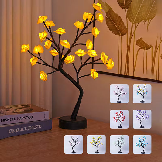 Decorative LED tree lamp on a wooden surface with color-changing options displayed.