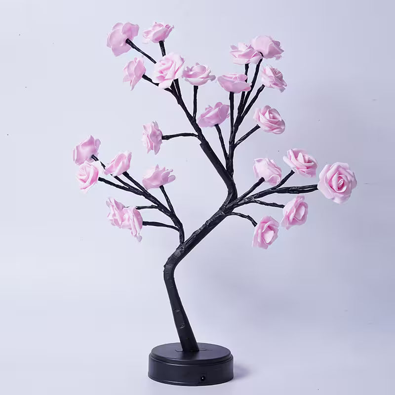 Decorative LED tree with pink flowers on a white background
