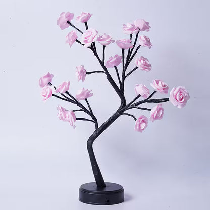 Decorative LED tree with pink flowers on a white background