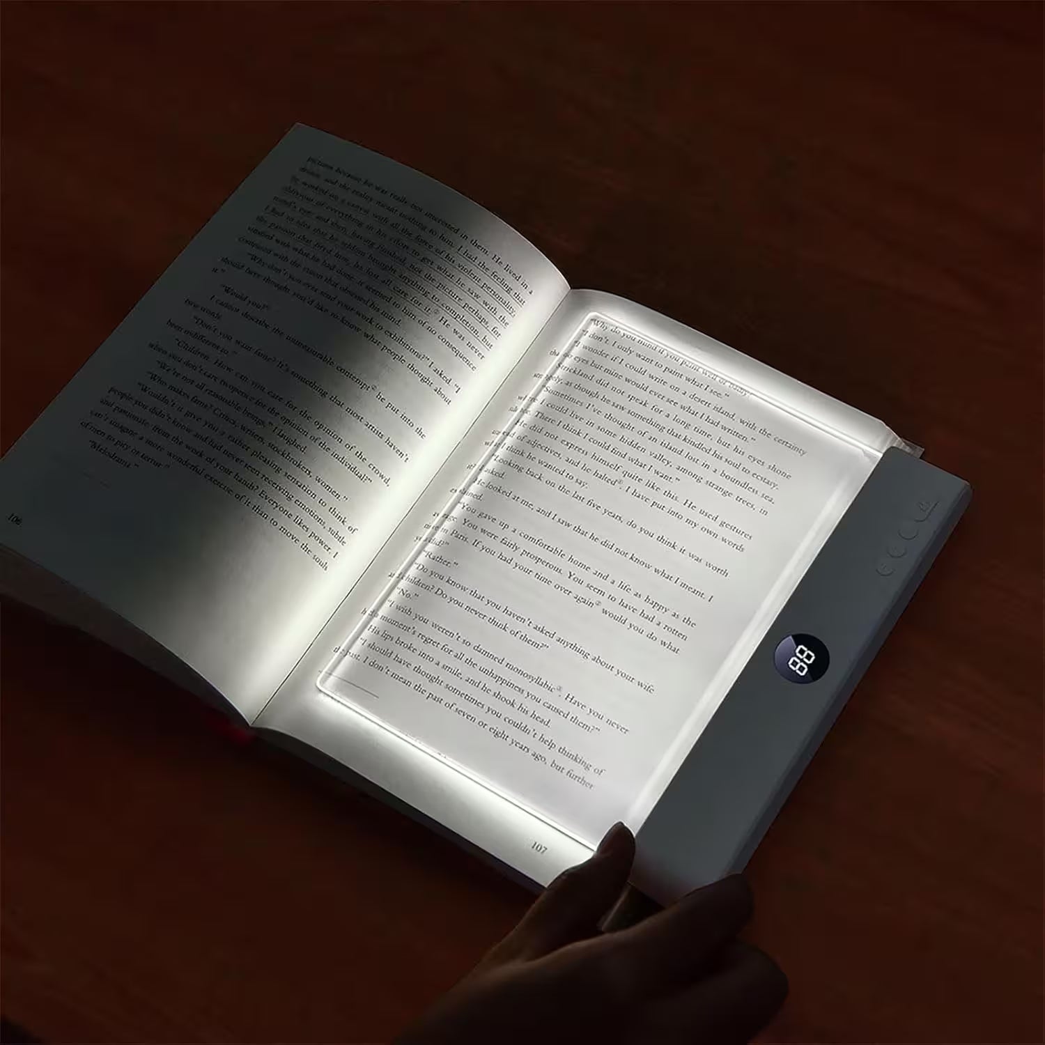 Open book with a light illuminating the text in a dark setting