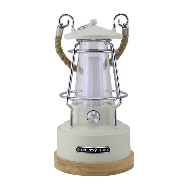 Camping lantern with wooden base and rope handle on a white background