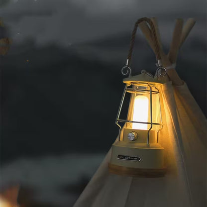 Camping lantern glowing in the dark with a cloudy sky background