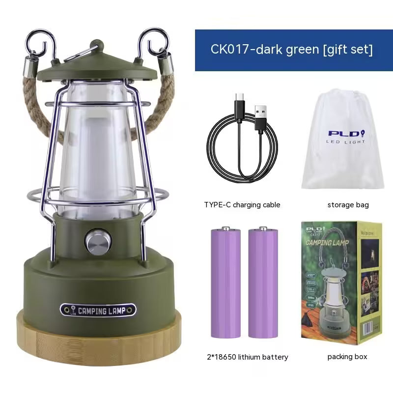 Green camping lantern with accessories including a charging cable, batteries, storage bag, and packaging box on a white background.