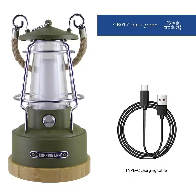 Green camping lantern with wooden base and USB charging cable on a white background