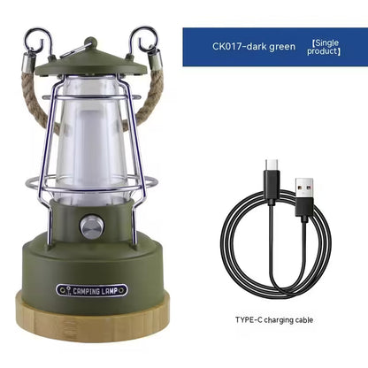 Green camping lantern with wooden base and USB charging cable on a white background