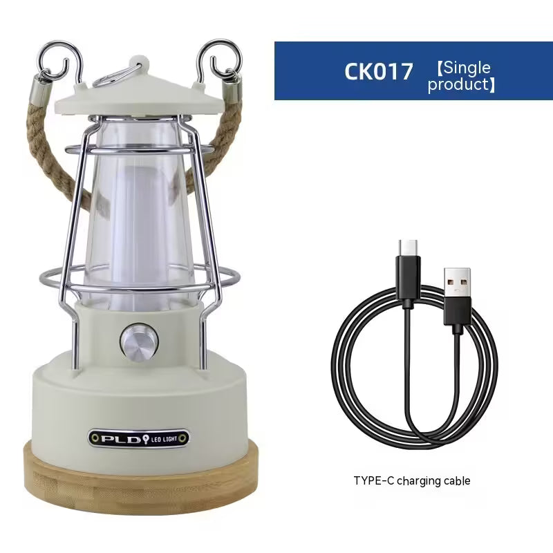 White camping lantern with wooden base and USB charging cable on a white background