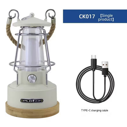 White camping lantern with wooden base and USB charging cable on a white background