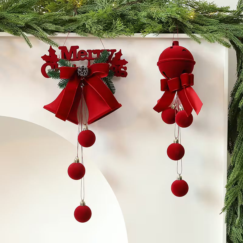 Red Christmas ornaments with bows and balls hanging against a white background.