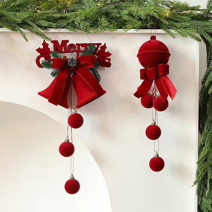 Red Christmas ornaments with bows and balls hanging against a white background.