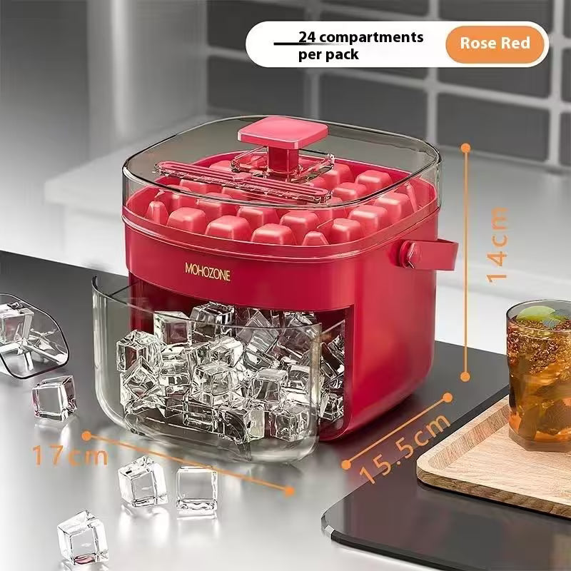 Red ice cube maker with transparent lid on a kitchen counter, showing ice cubes and a glass of iced tea.