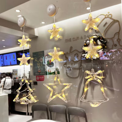 Decorative hanging lights shaped like stars, trees, and bells in a restaurant setting.