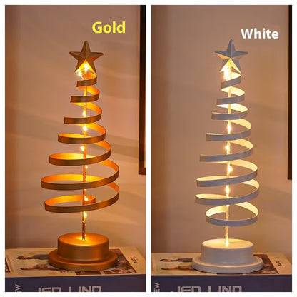 Two spiral table lamps, one gold and one white, on a neutral background.