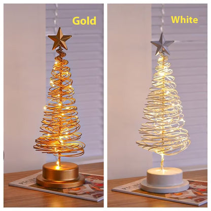 Two LED Christmas tree lights, one gold and one white, on a table with a neutral background.