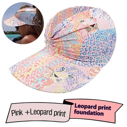 Pink and leopard print visor hat with a person wearing it inset.