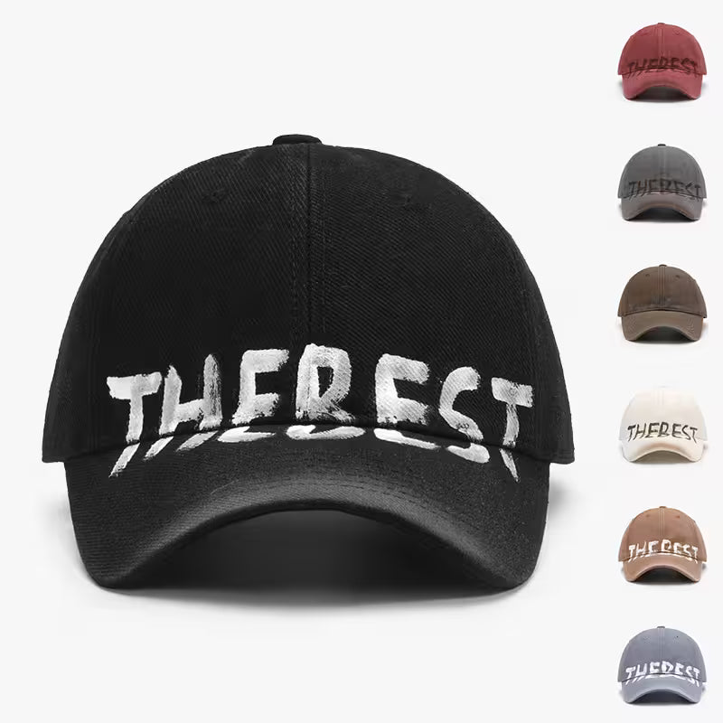 Black cap with 'THE BEST' text in white, displayed with other color options on a white background.