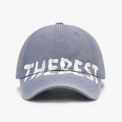Gray cap with 'THE BEST' text on a white background
