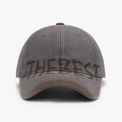 Gray cap with 'THE BEST' text on a white background