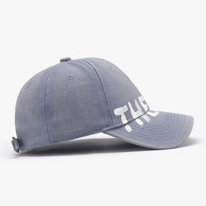 Blue baseball cap with 'THE' logo on a white background