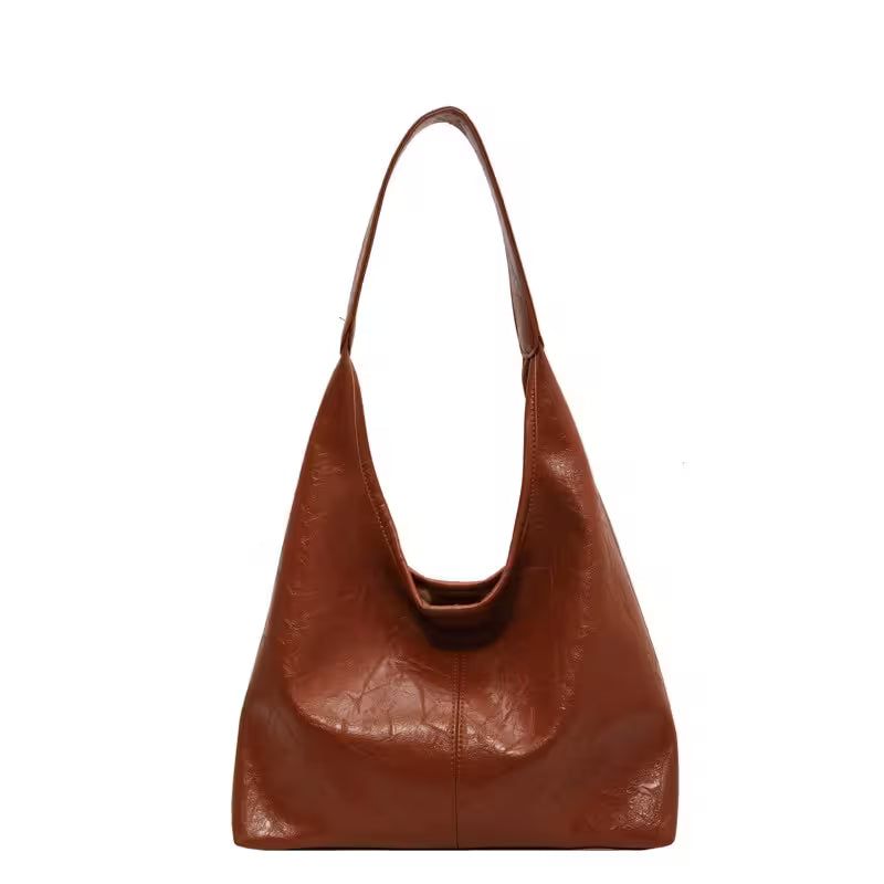 Brown leather handbag on a white background